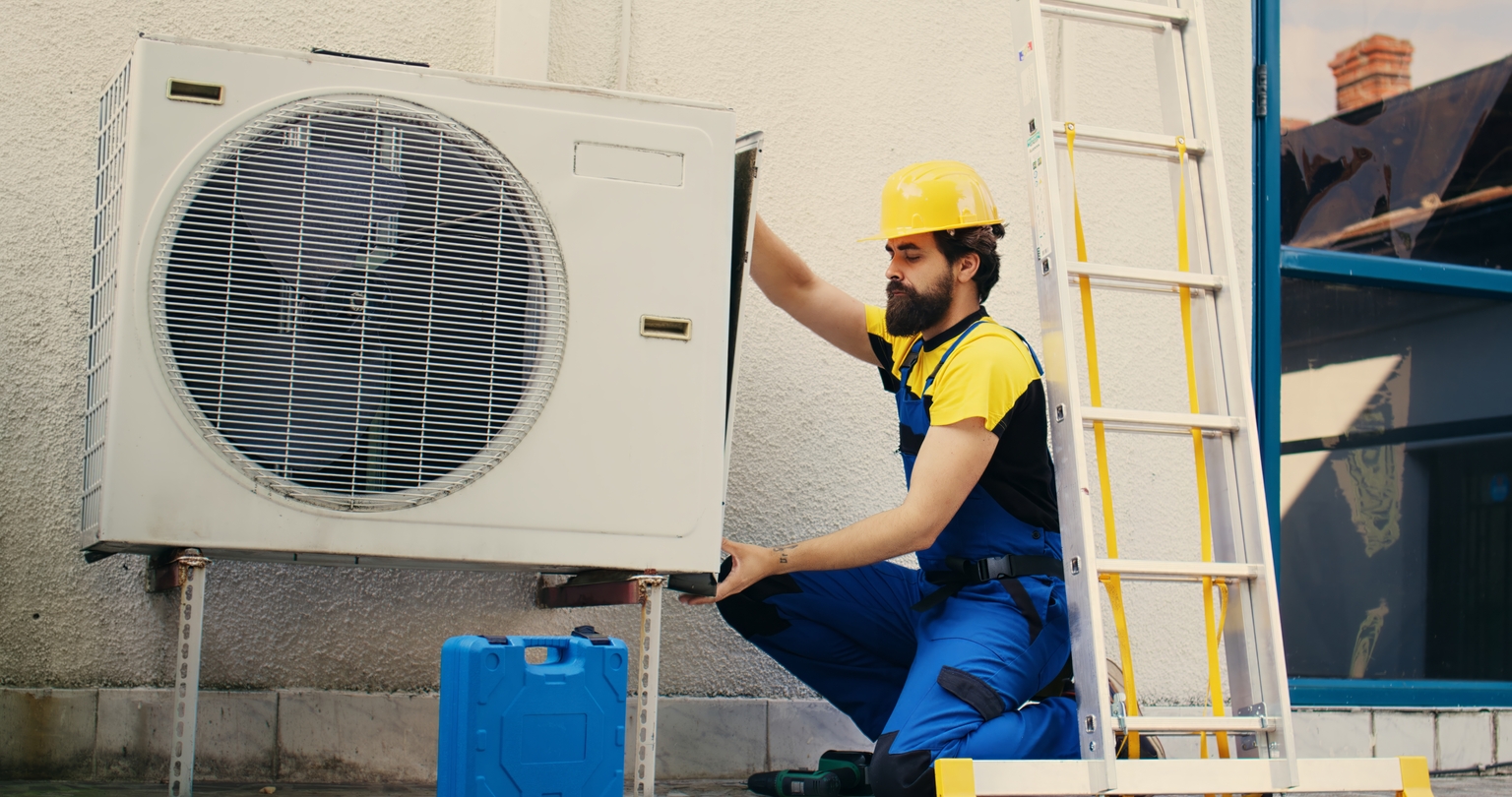 Worker works on air conditioner